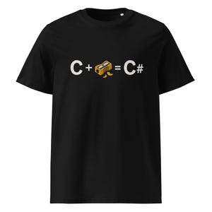 May include: Black t-shirt with a graphic design. The design features the letters "C" and "C#" with a pencil sharpener and the plus and equals signs. The pencil sharpener is yellow and the text is white.