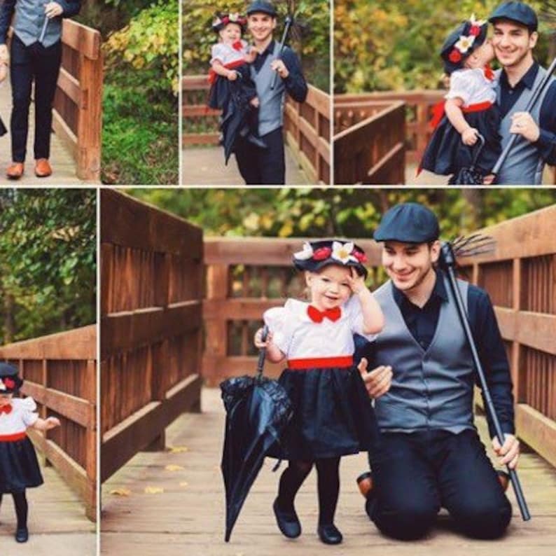 May include: A father and daughter dressed as chimney sweeps from the movie Mary Poppins. The girl is wearing a black dress, a red bow, and a white hat with a flower. The father is wearing a black vest, a black hat, and a black umbrella.