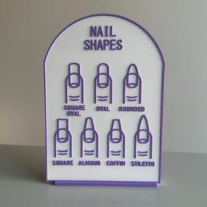 May include: A white and purple sign showing various nail shapes. The sign features the text "NAIL SHAPES" and illustrations of square, oval, rounded, square oval, almond, coffin, and stiletto nail shapes.
