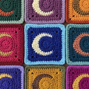 May include: A collection of square crochet patches arranged in a grid. Each patch features a central crescent moon motif in a contrasting color against a solid background. The squares are worked in various colors including blue, purple, orange, red, and green.