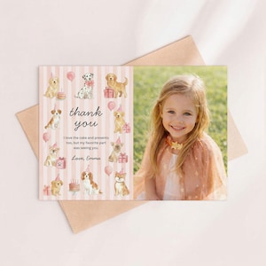 May include: A personalized thank you card featuring a photo of a smiling child. The card has a pink striped background with watercolor illustrations of dogs wearing party hats and holding gifts. The text reads "thank you" and a personal message.