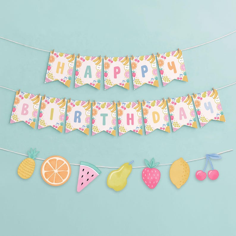 May include: A festive birthday banner with the words "HAPPY BIRTHDAY" spelled out on colorful pennants. The pennants are decorated with various fruits, and a string of fruit cutouts hangs below, including a pineapple, orange slice, and watermelon.