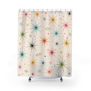 May include: A shower curtain with a retro space-themed design. The cream-coloured curtain features a repeating pattern of colourful starbursts in shades of red, blue, green, yellow, and black, with small dots and planet illustrations.
