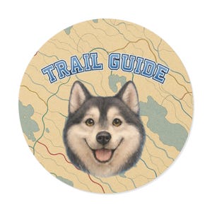 May include: Round sticker with a smiling husky dog face and the words "TRAIL GUIDE" in blue. The background is a map design with green and red lines, and blue water features.