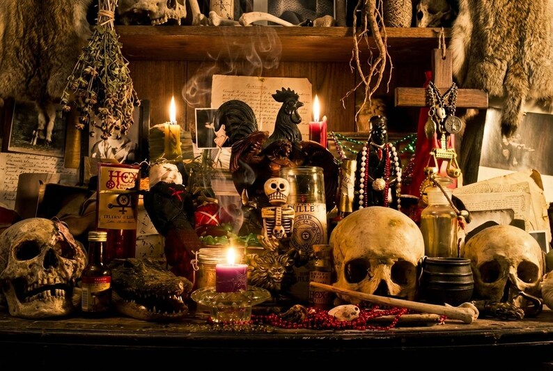 May include: A dimly lit display of occult items, including skulls, candles, and bottles. A black rooster statue and a skeleton figurine are also present. The scene evokes a sense of mystery and ritual, with a focus on spiritual or magical practices.