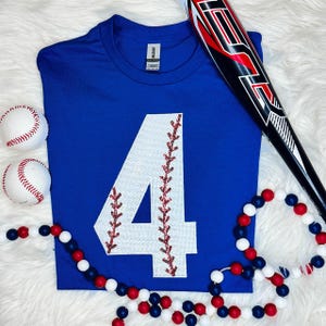 Baseball Number Sequin Patch, blue sports jersey with a large white number 4 adorned with red sequin stitching