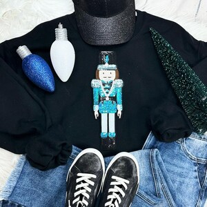 May include: A set of three ceramic mugs with a speckled, matte finish. The mugs are in shades of cream, light gray, and dark gray. Each mug has a simple, minimalist design, perfect for coffee or tea.