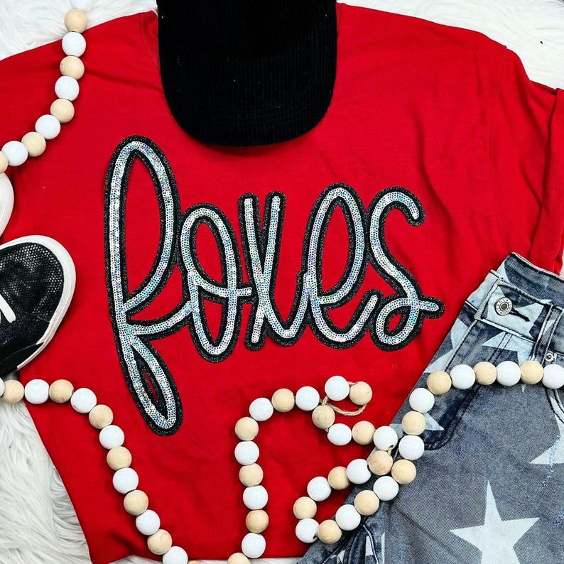 Foxes Sequin Patch, colorful embroidered fox design embellished with shiny sequins on red fabric.