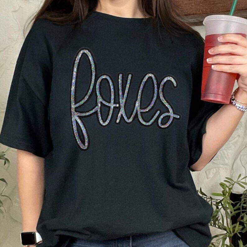 Foxes Sequin Patch, black t-shirt with the word 'foxes' in colorful sequins.