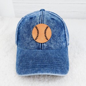 Baseball Softball Leather Hat Patch, Denim baseball cap with a leather patch featuring a baseball design with black stitched seams.