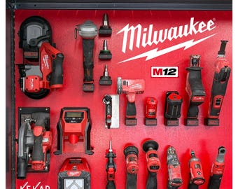 May include: A red display board with various Milwaukee power tools. The tools are red and black, including saws, drills, and grinders. The Milwaukee logo is prominently displayed in white. The display also features the text "KEKAP DESIGNS".