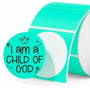 May include: A roll of turquoise round stickers with the text "i am a CHILD OF GOD" in black. The stickers have a crown and heart designs. The roll is partially unrolled, revealing the white backing.