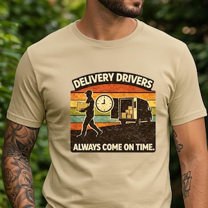 May include: Beige t-shirt with a graphic that reads "Delivery Drivers Always Come On Time." The design shows a delivery person silhouette, a clock, and a van against a sunset background.