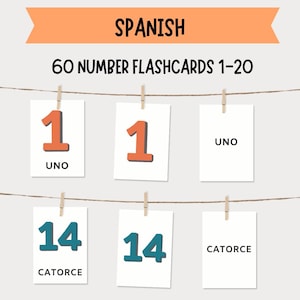 Puede incluir: Un conjunto de 60 tarjetas de números en español, del 1 al 20, exhibidas en una cuerda con pinzas. Las tarjetas presentan números en naranja y verde azulado, con las palabras en español "UNO" y "CATORCE" debajo. Una pancarta naranja en la parte superior dice "ESPAÑOL".