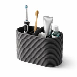 Könnte beinhalten: Ein dunkelgrauer, gerippter, ovaler Organizer mit Zahnpflegeprodukten. Eine elektrische Zahnbürste, eine Holzzahnbürste, Zahnpasta, Mundwasser und eine kleine Seife sind sichtbar. Der Organizer hat mehrere Fächer.