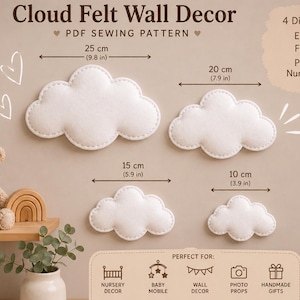 May include: A PDF sewing pattern for Cloud Felt Wall Decor featuring four white cloud shapes in sizes 25 cm (9.8 in), 20 cm (7.9 in), 15 cm (5.9 in), and 10 cm (3.9 in). The document includes icons for print, cut, sew, and instant download.