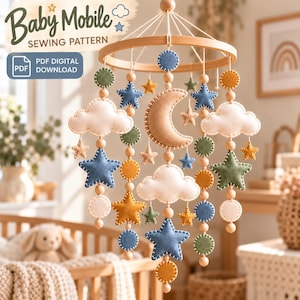 Op de afbeelding: Een baby mobiel naaipatroon als PDF digitale download met een rond houten frame en hangende viltvormen waaronder een halve maan, wolken, sterren en cirkels in blauw, groen, geel en crème, geaccentueerd met houten kralen.