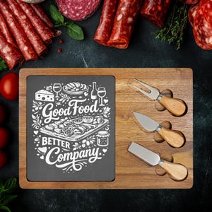 May include: Wooden charcuterie board with a slate insert featuring the text "Good Food, Better Company." Includes three cheese knives and a cheese fork with wooden handles. Salami and tomatoes are in the background.