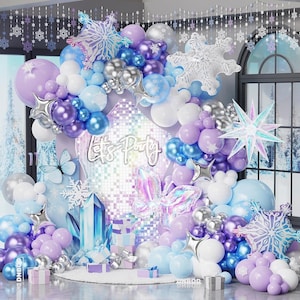 May include: A balloon arch decoration featuring purple, blue, white, and silver balloons, large snowflake foil balloons, a holographic butterfly balloon, and a neon sign reading Let's Party. Includes crystal-shaped accents and gift boxes.
