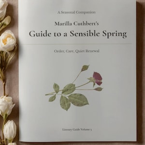 May include: A book titled "Guide to a Sensible Spring" with a floral illustration. The cover features the text "Guide to Spring Cleaning the Home and the Heart" and "Marilla Cuthbert's Guide to a Sensible Spring". A sprig of roses is displayed on the cover.