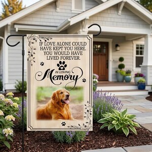 May include: A garden flag with a Golden Retriever image and the text "IF LOVE ALONE COULD HAVE KEPT YOU HERE. YOU WOULD HAVE LIVED FOREVER. IN LOVING MEMORY." The flag is displayed in a garden.