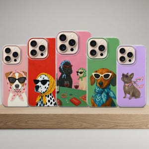 May include: A collection of phone cases featuring illustrated dogs wearing sunglasses and scarves. The cases have different colored backgrounds, including pink, red, green, and purple. The dogs are depicted in various breeds and poses, adding a playful and stylish touch.