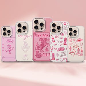 May include: Five pink and white phone cases with cowgirl-themed designs. The cases feature illustrations of a cowgirl, martini glass, a cowgirl riding a horse, boots, hats, and other western motifs. The cases have clear edges.