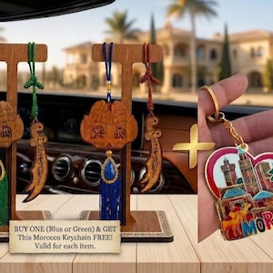 May include: Two wooden car ornaments hanging on T-shaped stands, each featuring a carved wooden plaque with Arabic calligraphy, a curved sword charm, and a tassel in green or blue. A heart-shaped Morocco keychain with a camel and palm tree graphic.