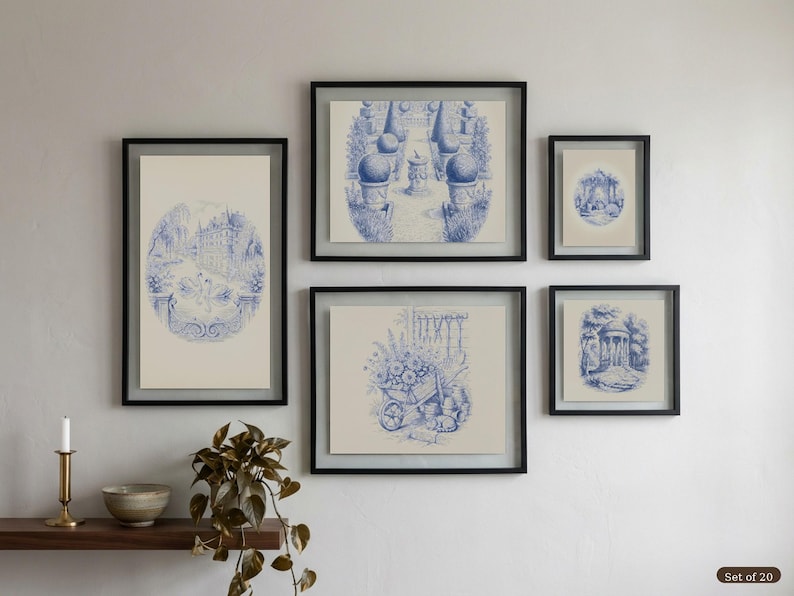 May include: A collection of five framed prints with blue and white illustrations of garden scenes. The prints are in black frames, arranged on a white wall. The artwork includes depictions of architectural elements. A shelf with decorative items is positioned below the framed prints.