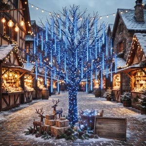 May include: A leafless tree illuminated with bright blue LED icicle lights, positioned in a cobblestone square. Two wooden reindeer figurines stand beside wrapped gift boxes, a woven basket filled with lights, and a blank wooden sign.