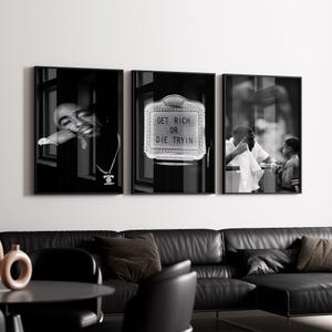 May include: A triptych of framed black and white photographs. The left image features a man leaning on a window. The center image displays a sign with the text "GET RICH OR DIE TRYIN". The right image shows two people. The images are displayed above a black leather sofa.