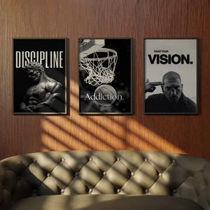 May include: Three framed black and white motivational posters. The first reads "DISCIPLINE" above a statue. The second shows a basketball going into a hoop with the word "Addiction." The third says "TRUST YOUR VISION."