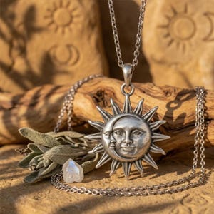 May include: A silver-toned metal pendant necklace featuring a sun and crescent moon face design with radiating rays. The pendant hangs from a matching silver-toned chain, showcasing a detailed celestial motif with a polished finish.