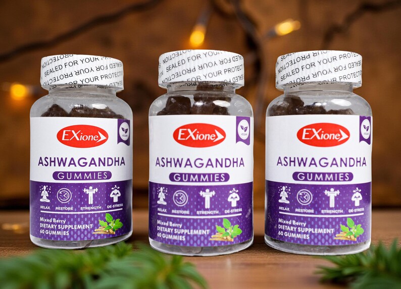 May include: Three clear plastic bottles of Ashwagandha Gummies. Each bottle has a white label with the brand name "Exione" and the product name. The label also includes the words "Relax, Restore, Strength, De-Stress". The bottles are filled with dark brown gummies.