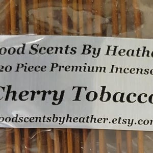 May include: A package of 20 premium incense sticks with a Cherry Tobacco scent. The label reads "Good Scents By Heather" and includes the Etsy shop's URL. The incense sticks are a light brown color.