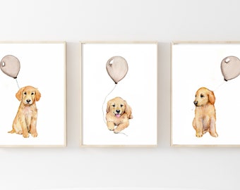 Puede incluir: Tres acuarelas de cachorros golden retriever sosteniendo globos. Cada cachorro está sentado y mirando hacia arriba al globo. Los globos son de color marrón claro.