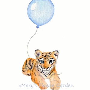 May include: A watercolor painting of a tiger cub lying down with a blue balloon floating above it. The tiger cub has orange and black stripes and blue eyes. The balloon is tied to a string that is attached to the tiger cub's paw.