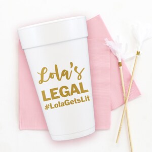 May include: White foam cup with gold lettering that says "Lola's LEGAL #LolaGetsLit" on a pink napkin with two white and gold party streamers.