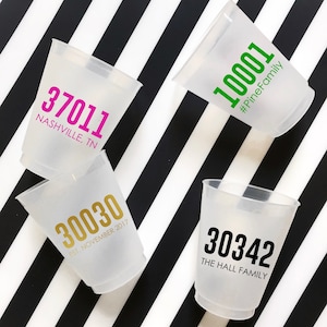 May include: Four clear plastic cups with different numbers and text printed on them. The numbers are 37011, 30030, 10001, and 30342. The text on the cups includes "Nashville, TN", "EST, NOVEMBER 2017", "#PineFamily", and "THE HALL FAMILY".