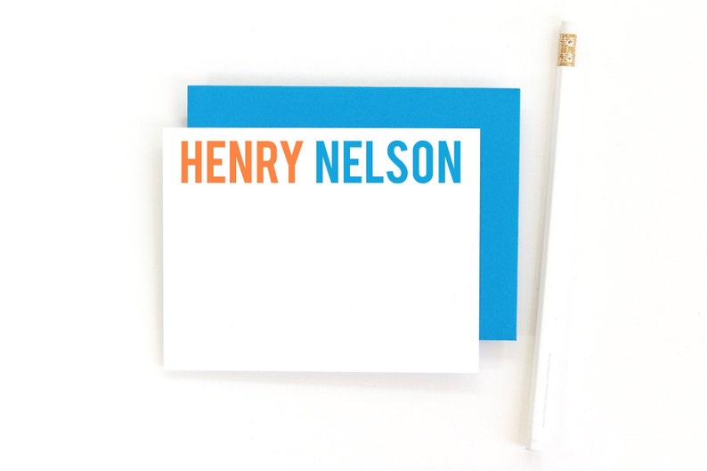 May include: A white card with a blue border and the text "HENRY NELSON" in orange and blue letters.