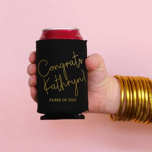 May include: Black can cooler with gold lettering that says "Congrats Kathryn! Class of 2021".