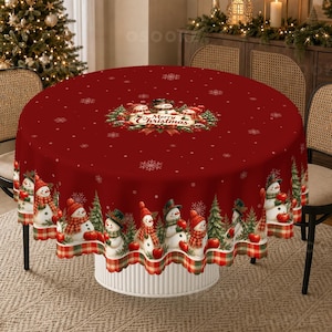 May include: A round red tablecloth featuring a repeating pattern of snowmen wearing scarves and hats, interspersed with green pine trees and white snowflakes. The center displays a circular graphic with snowmen and the text Merry Christmas.