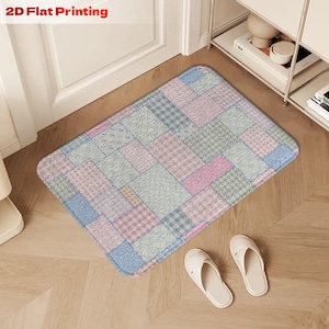 May include: A rectangular floor mat with a patchwork design in pastel colors of blue, pink, and green. The mat is placed in front of a white door. The text "2D Flat Printing" is in the top left corner.