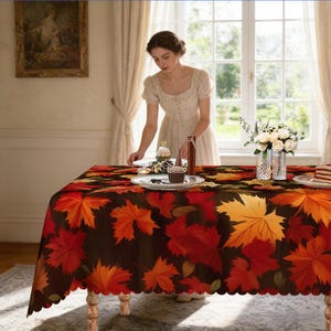 May include: A rectangular tablecloth with a brown background and a pattern of red, orange, and yellow maple leaves. The tablecloth is on a wooden table with a scalloped edge. A woman is setting the table.