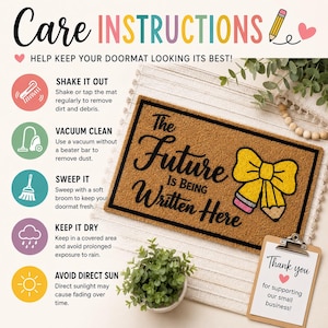May include: A rectangular brown coir doormat with a black border and the text The Future Is Being Written Here. A yellow bow and pencil graphic is printed on the right side. The image includes care instructions and a thank you note for customers.