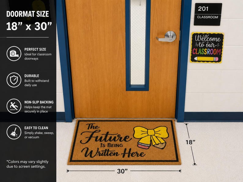 May include: A rectangular tan doormat measuring 45.72 cm by 76.2 cm with a black border. The mat features the black text 'The Future Is Being Written Here' and a graphic of a yellow bow tied around a pencil with a pink eraser and grey lead.