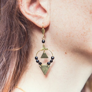 black and gold geometric hoop earrings with brass triangles.