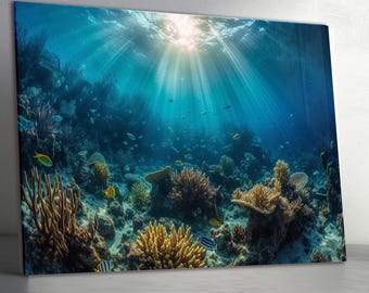 May include: A vibrant underwater scene featuring a coral reef with various coral formations in shades of yellow, brown, and purple. Sunlight streams through the water, illuminating the reef and the fish swimming around it. The artwork is displayed on a canvas.