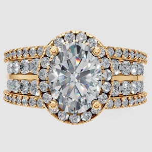 May include: A gold engagement ring with an oval-cut center stone, surrounded by a halo of smaller stones. Additional rows of smaller stones adorn the band, creating a sparkling, luxurious design.
