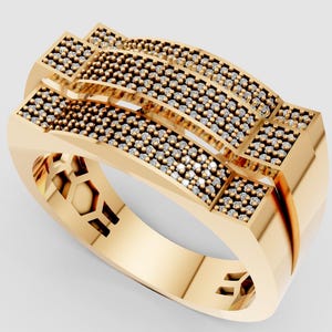 May include: A gold ring with a geometric design. The ring features multiple rows of small, dark-coloured stones set into the top surface. The band has a unique cut-out design. The ring is shown on a white background.